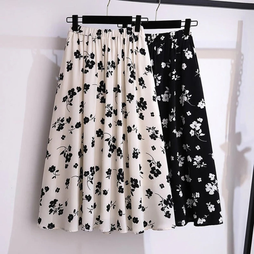 Cream midi skirt with black floral print, elastic waist.