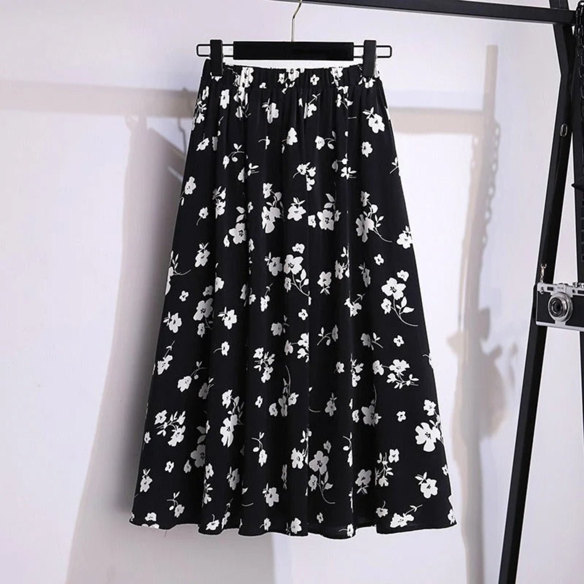 Cream midi skirt with black floral print, elastic waist.