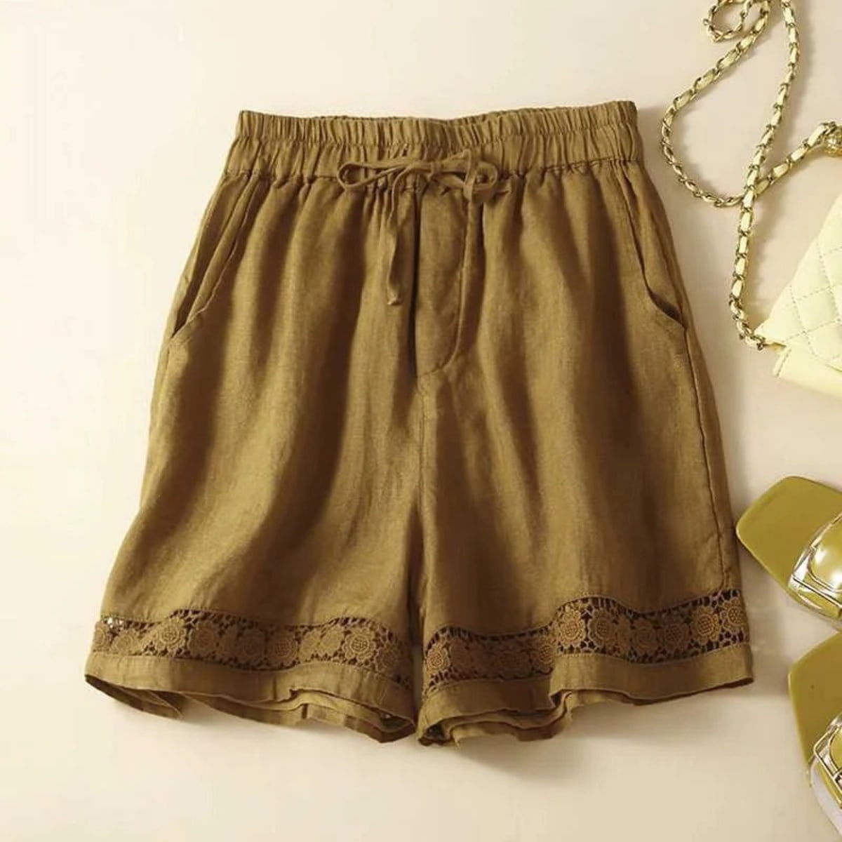 Relaxed floral shorts with embroidered hem and elastic waist.