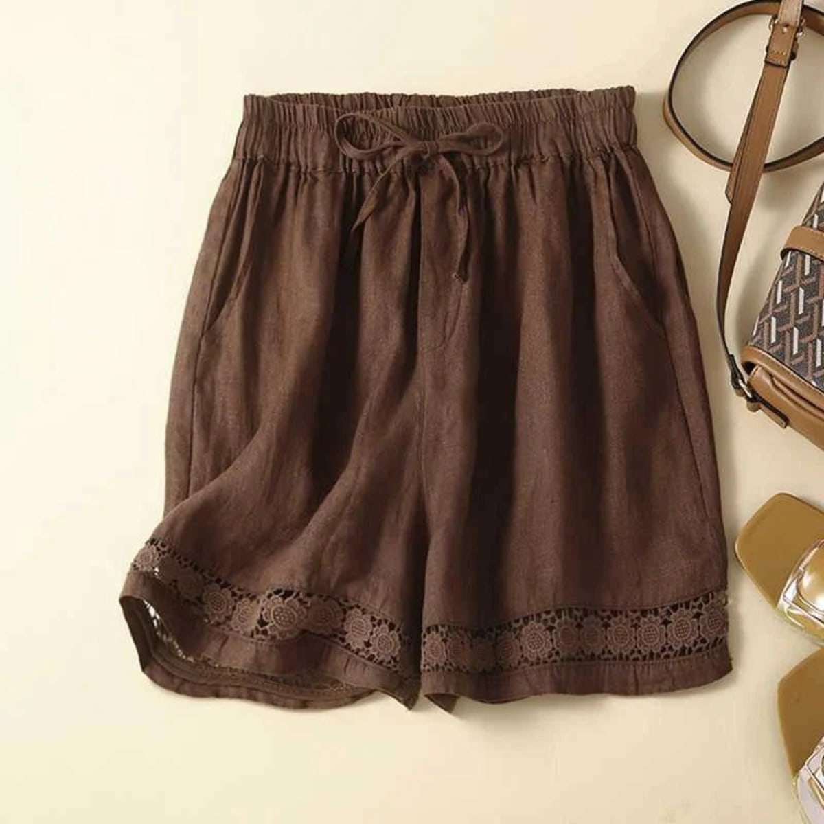 Relaxed floral shorts with embroidered hem and elastic waist.