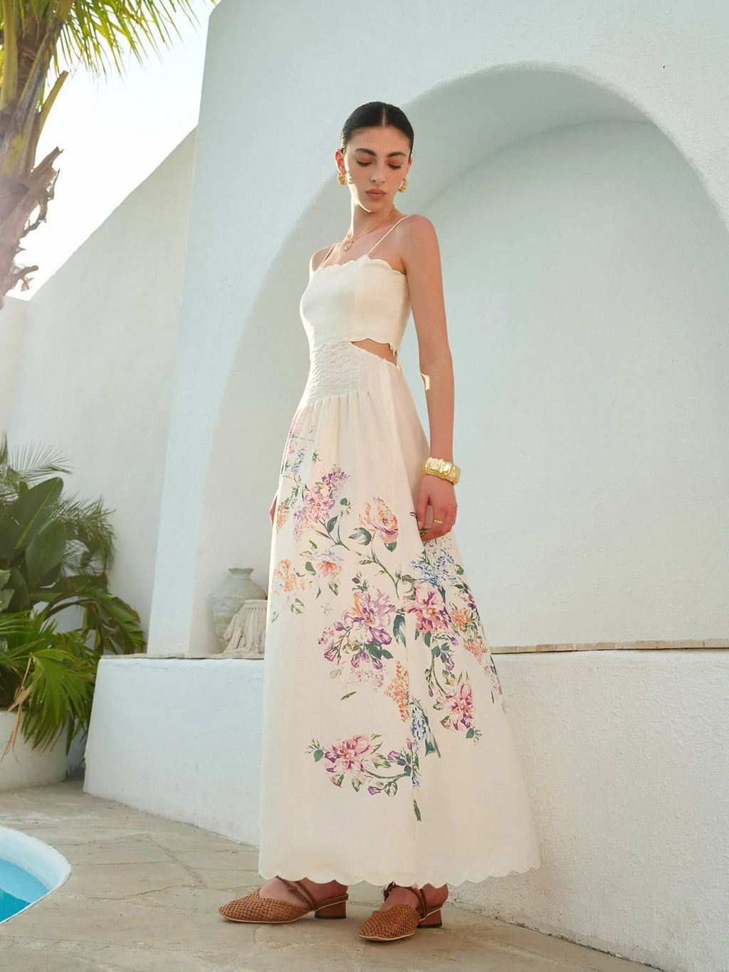 Floral maxi dress with cutout waist and scalloped hem.