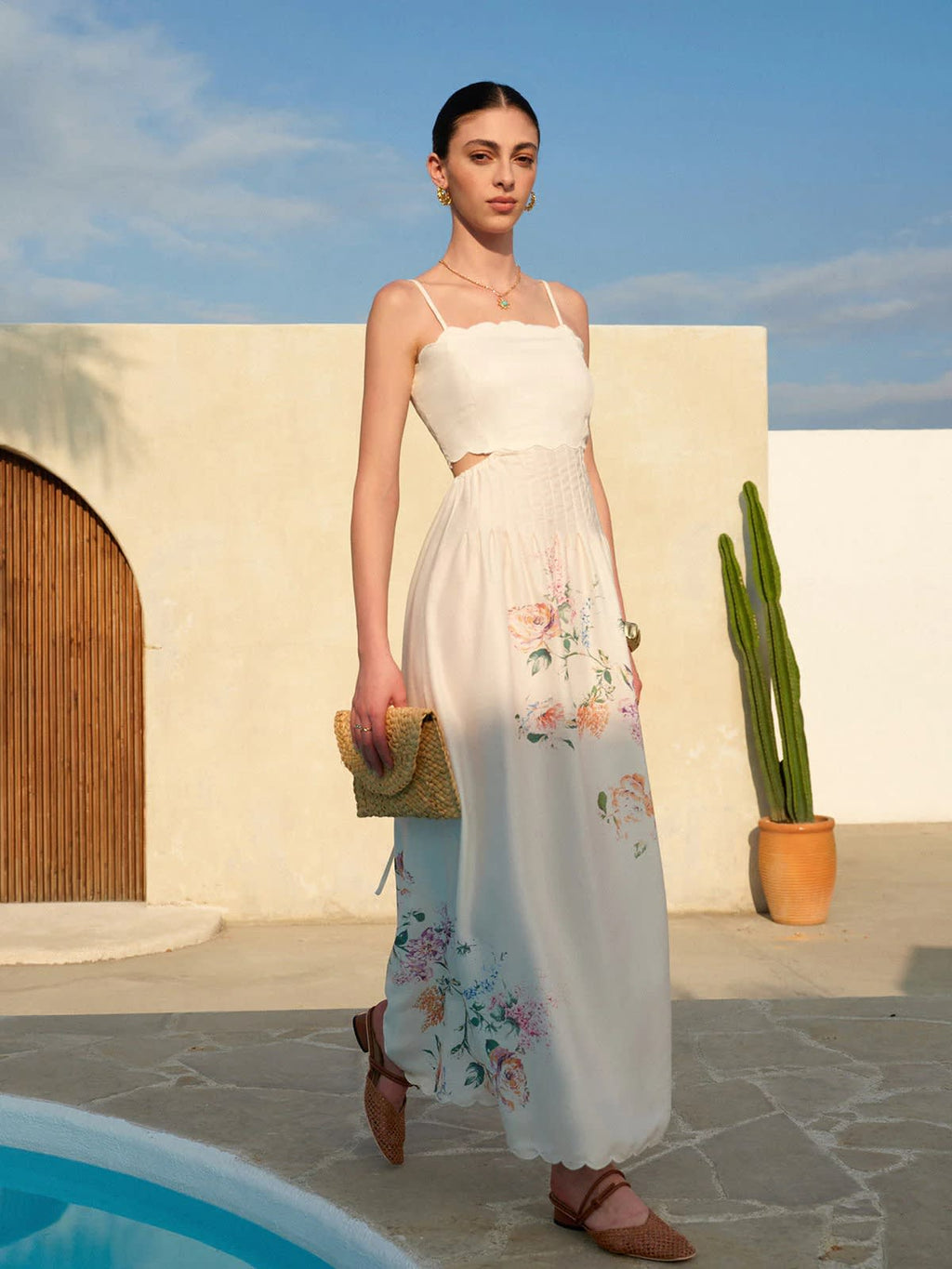 Floral maxi dress with cutout waist and scalloped hem.