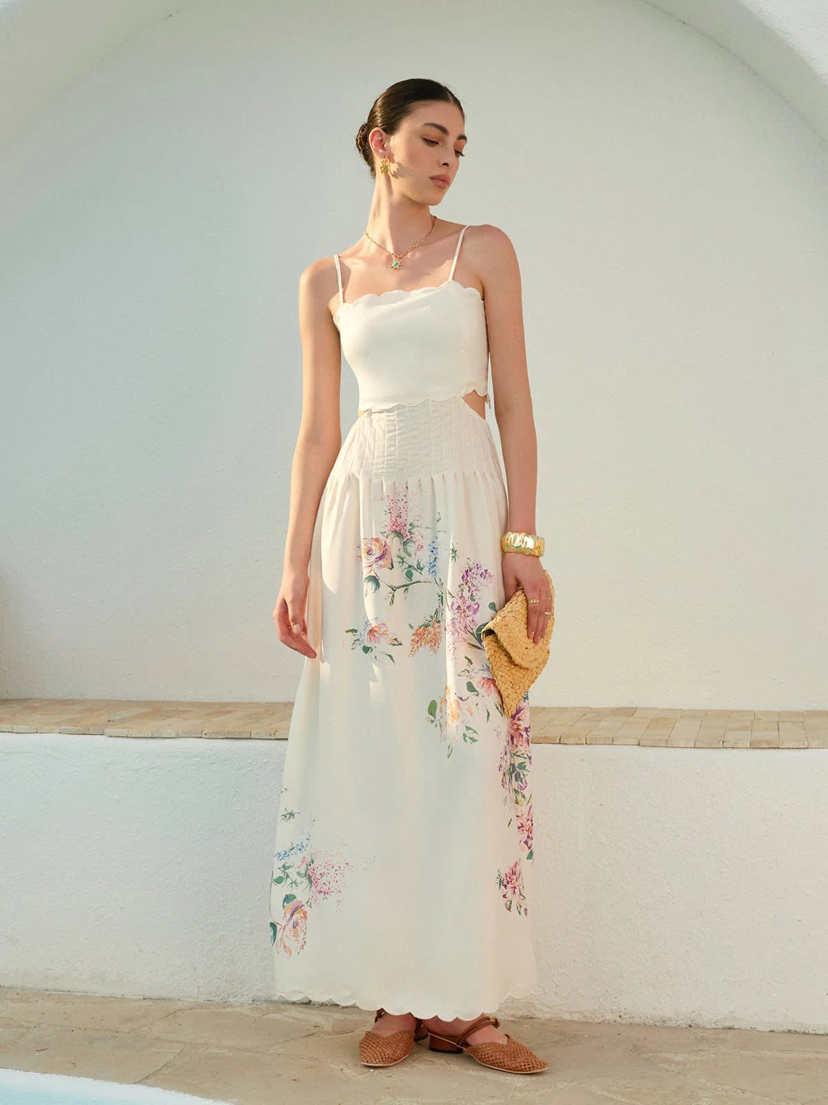 Floral maxi dress with cutout waist and scalloped hem.