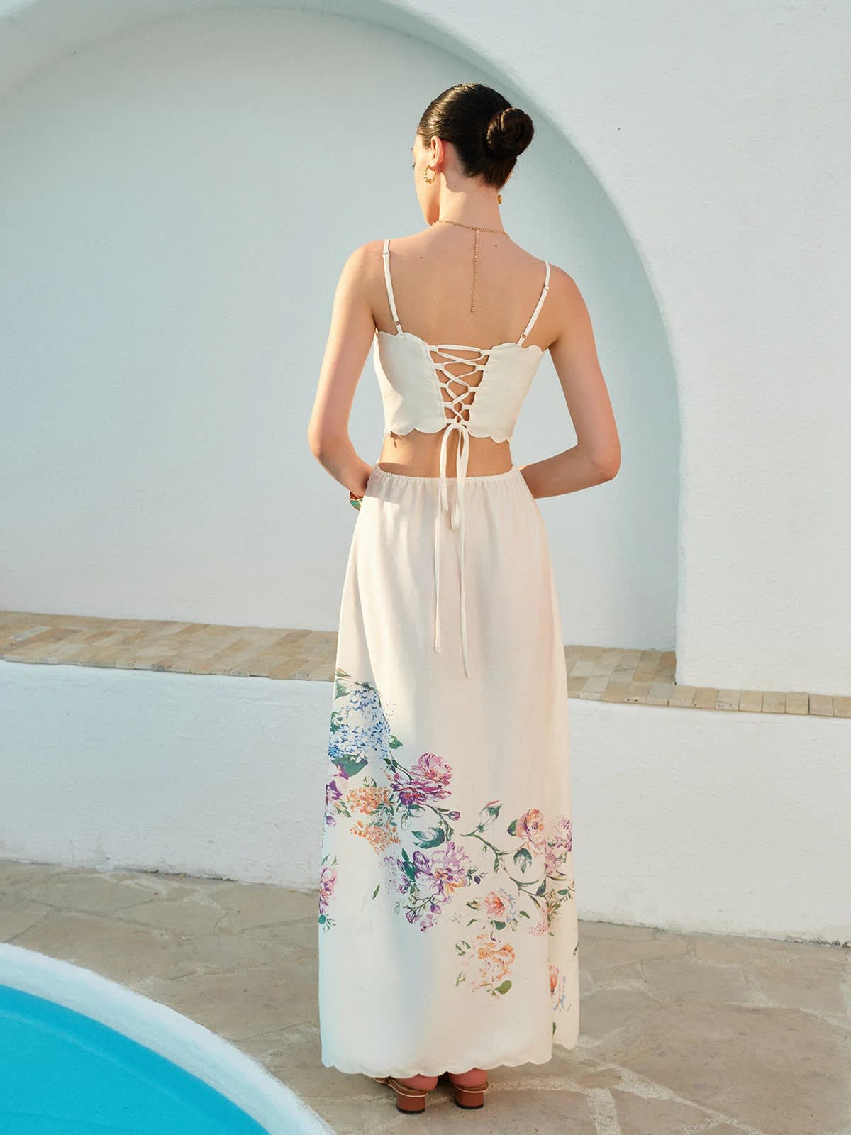 Floral maxi dress with cutout waist and scalloped hem.