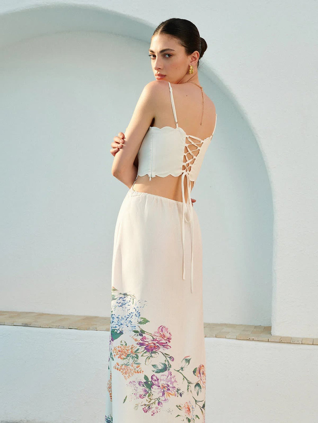 Floral maxi dress with cutout waist and scalloped hem.