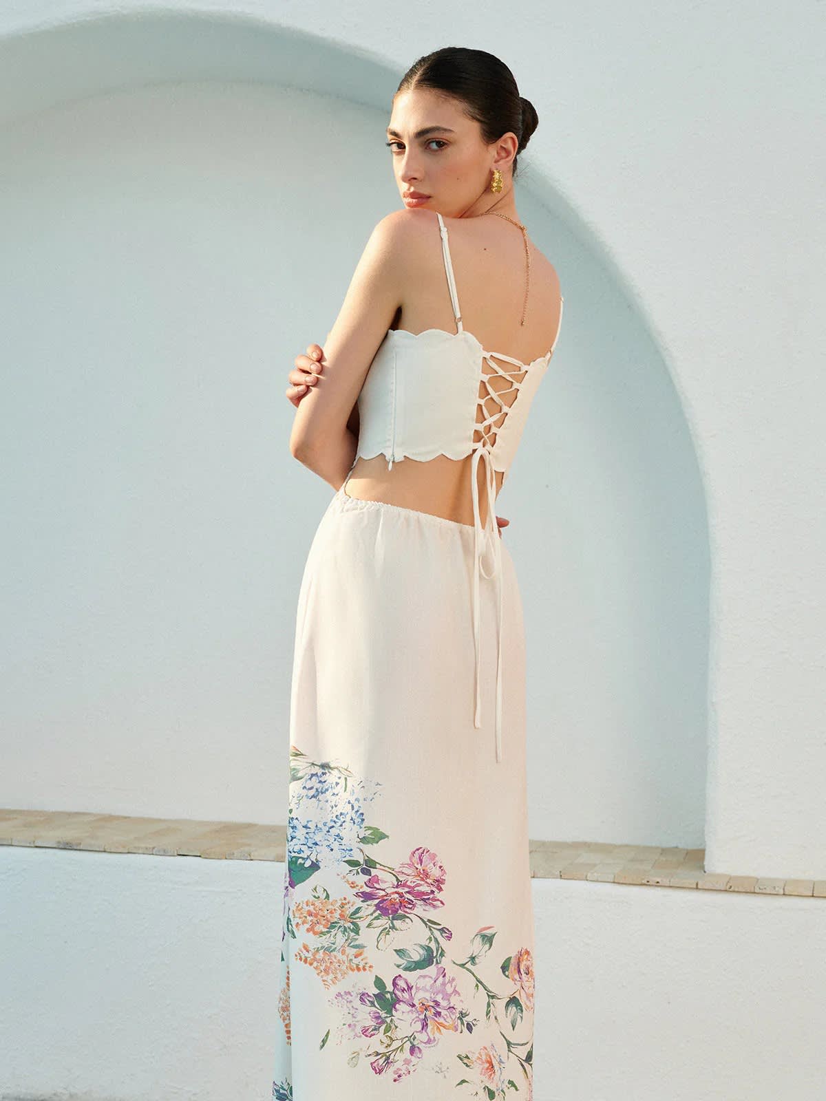 Floral maxi dress with cutout waist and scalloped hem.