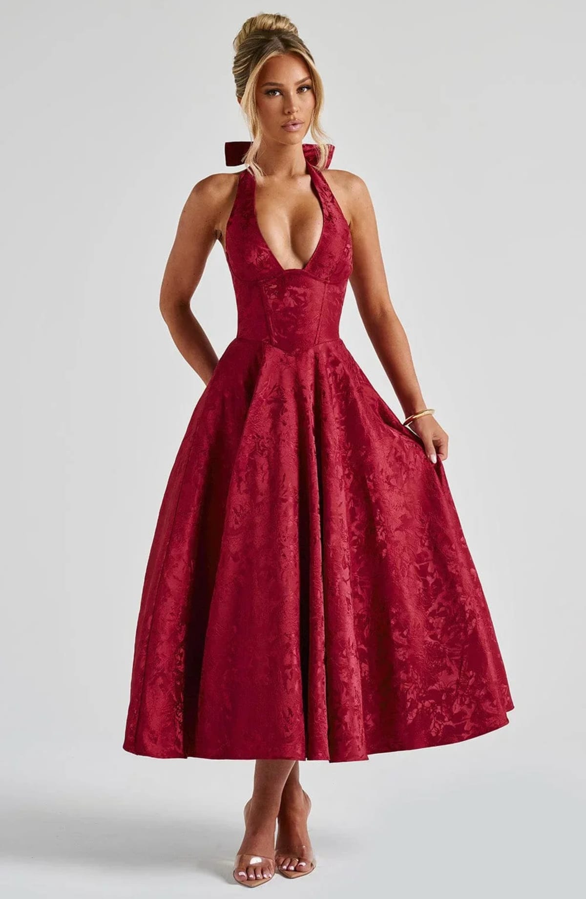 Woman in halter neck midi dress with deep V-neckline and flared skirt