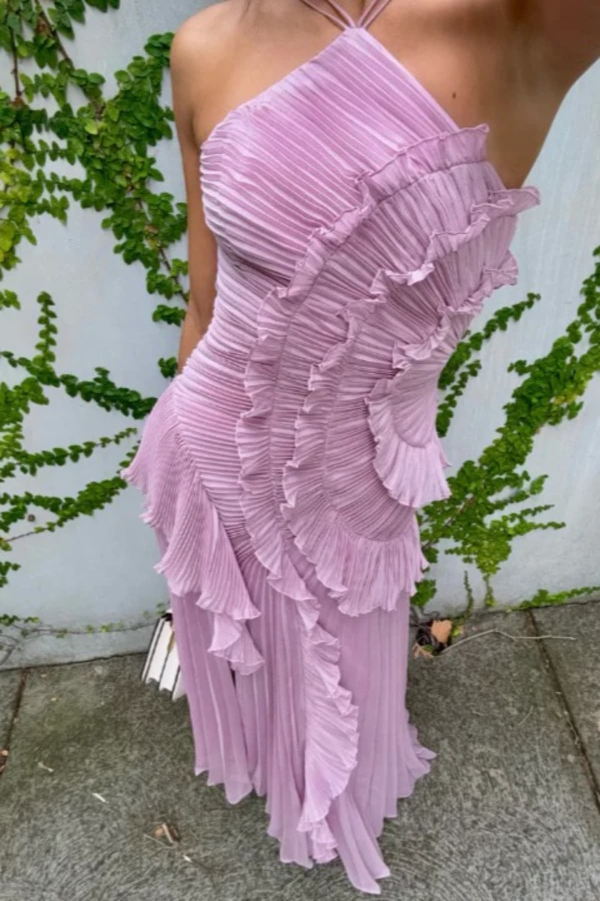 Halter dress with sculpted pleats and flowing skirt for special occasions.