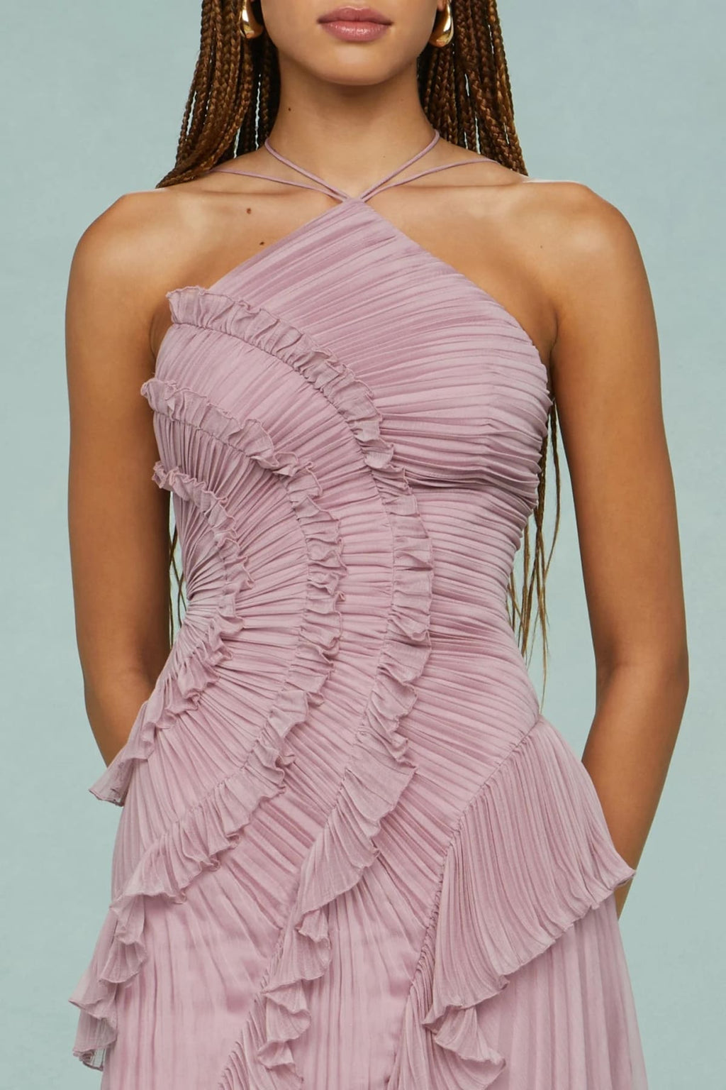 Halter dress with sculpted pleats and flowing skirt for special occasions.