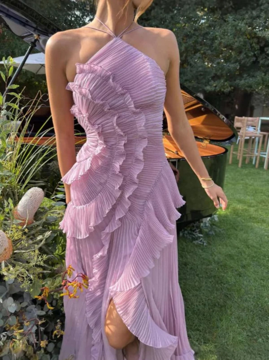 Halter dress with sculpted pleats and flowing skirt for special occasions.