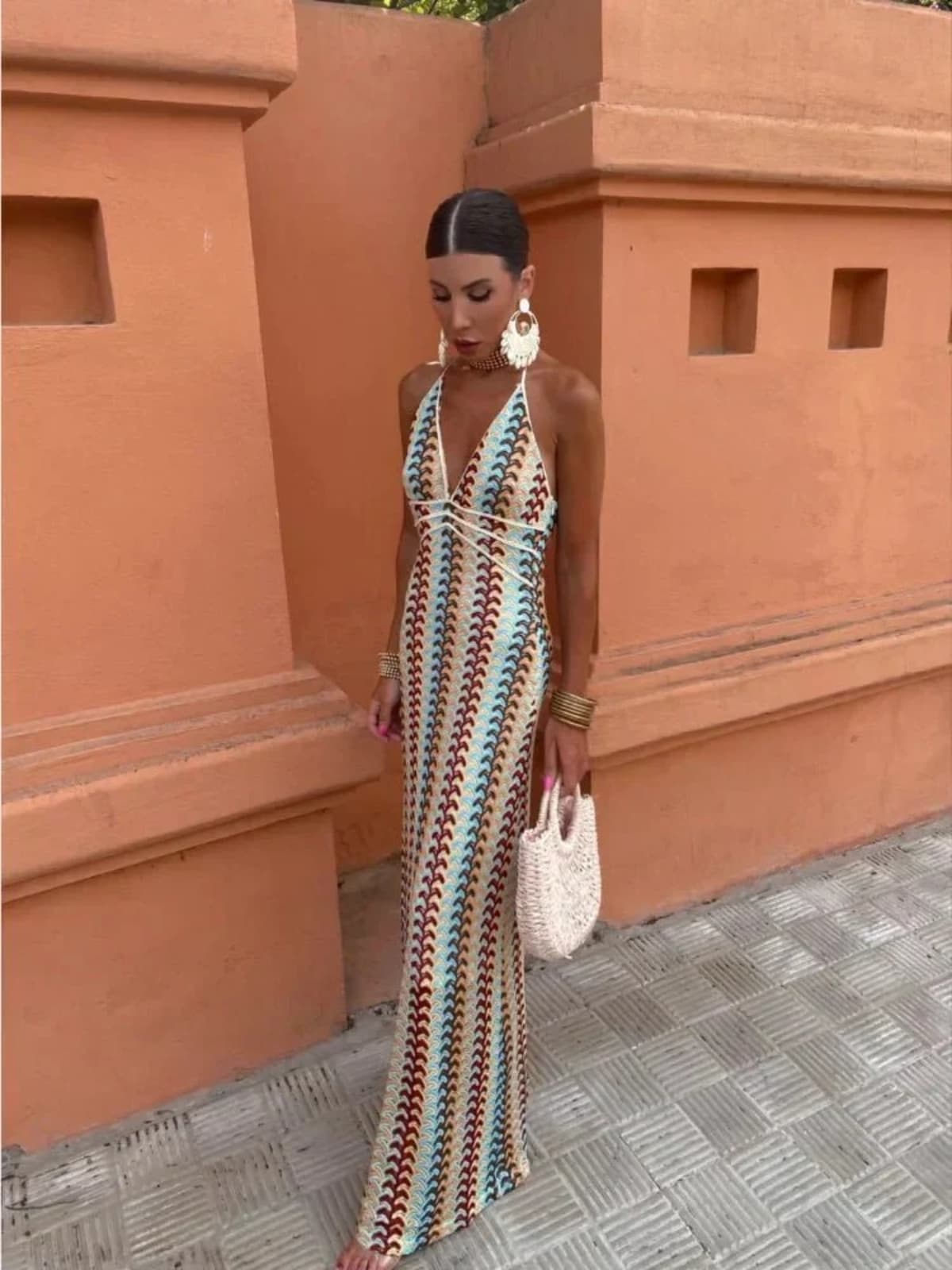 Long-line dress with structured neckline and streamlined fit.