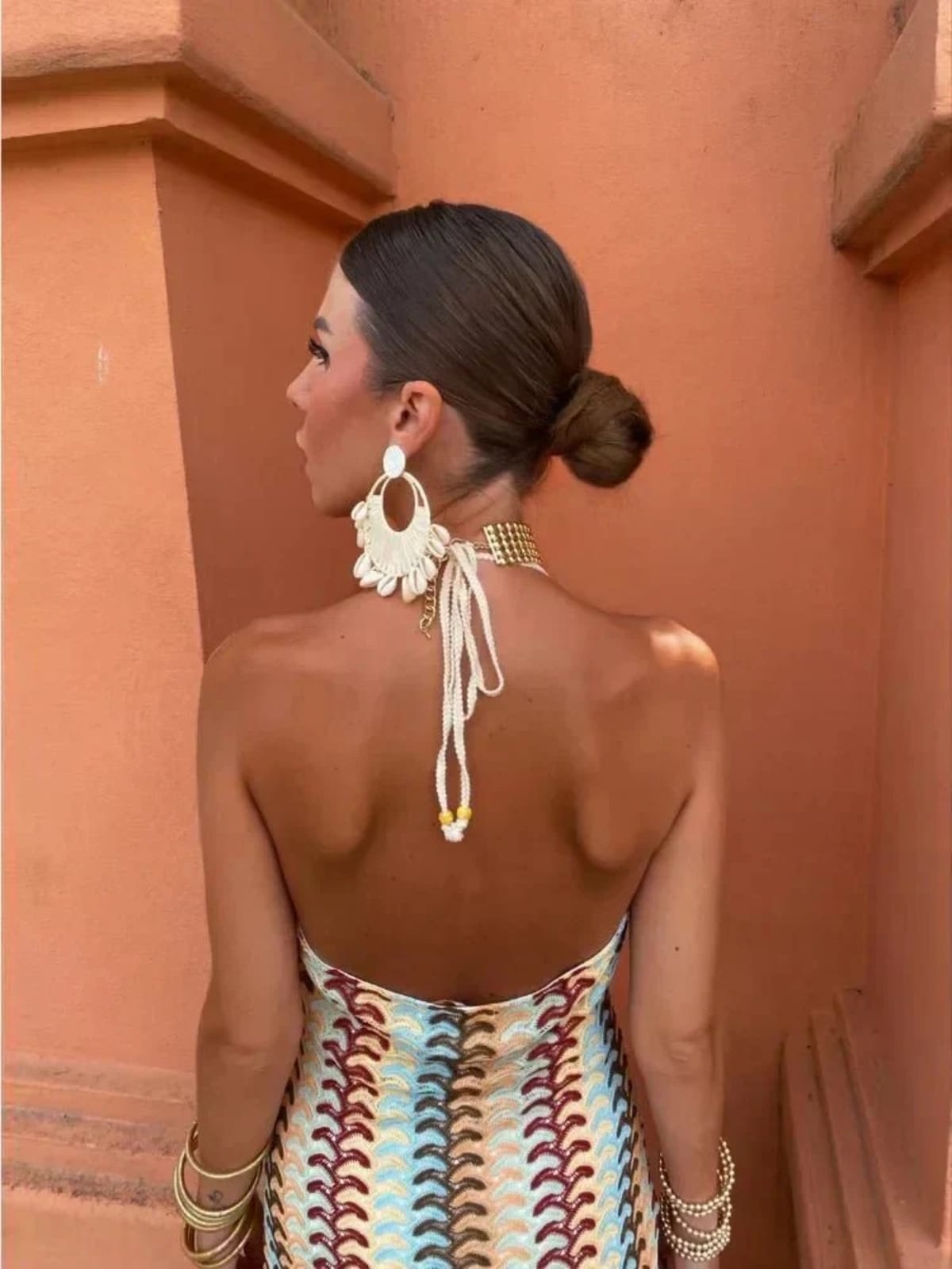Long-line dress with structured neckline and streamlined fit.