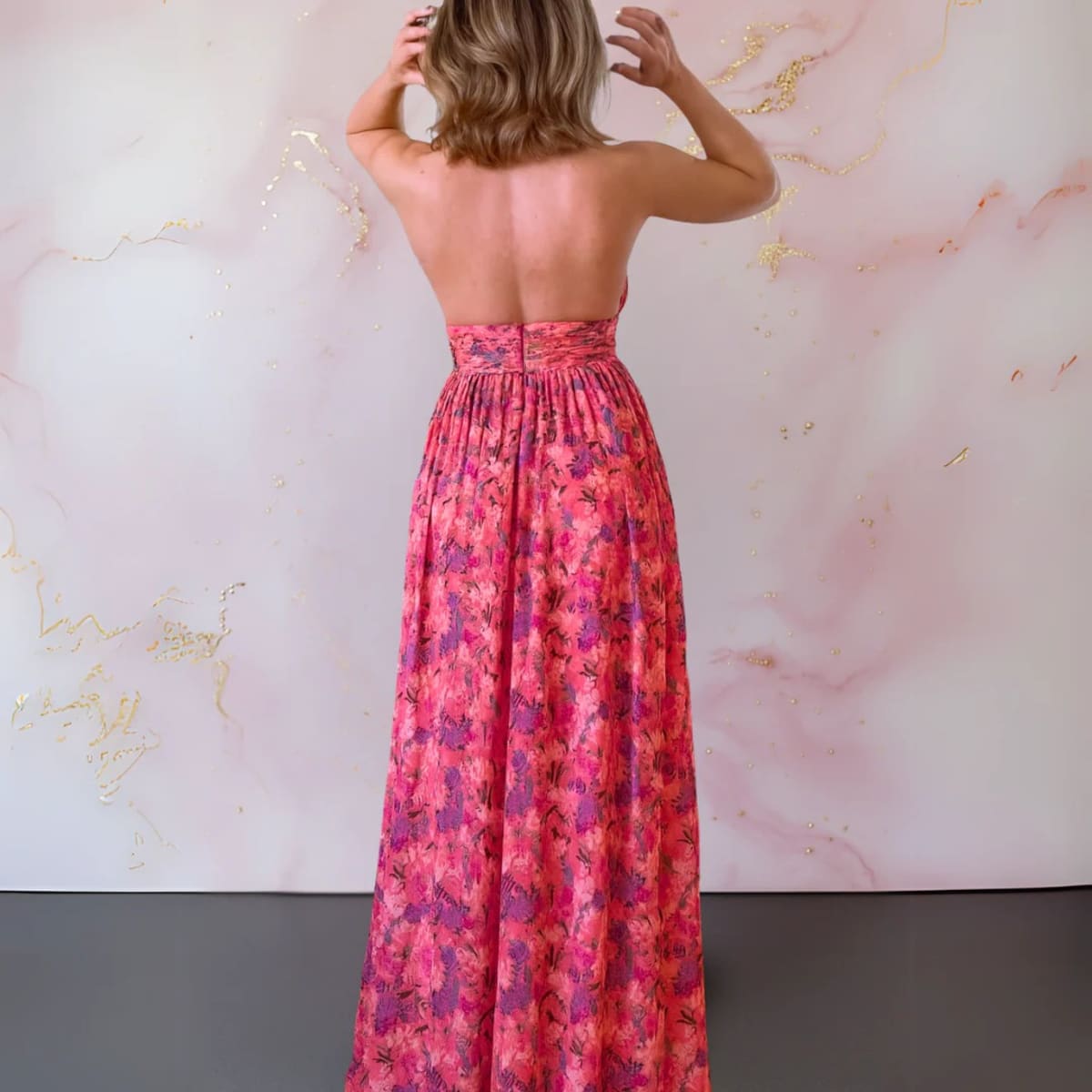 Floral maxi dress with open back and flowing silhouette.