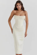 Woman wearing strapless midi dress with pearl and beaded fringe.