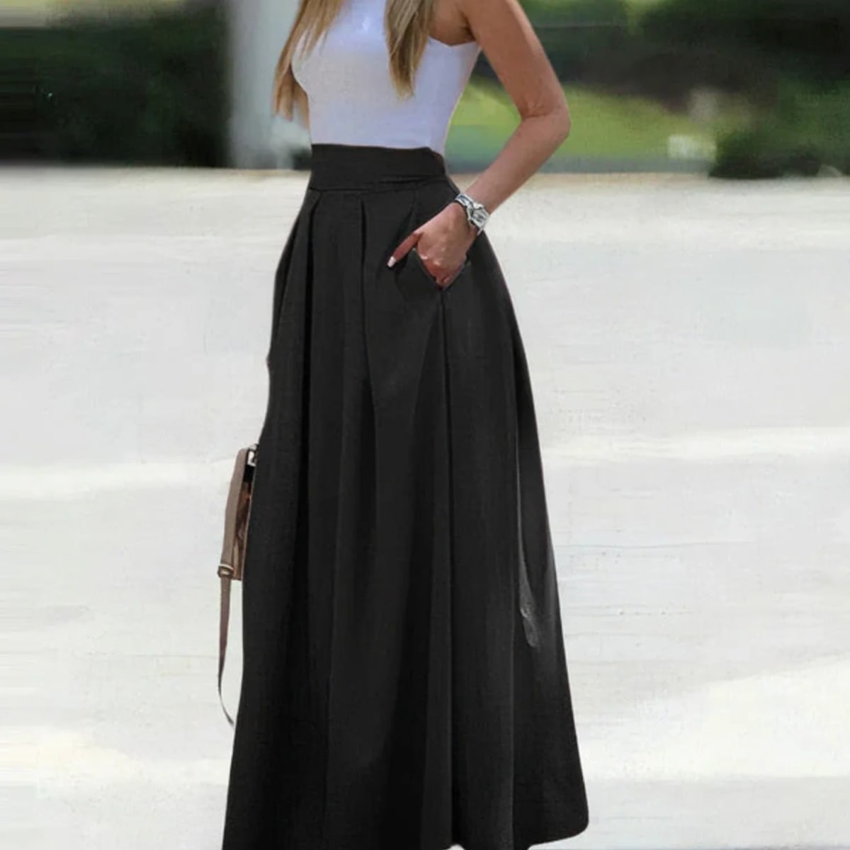 Woman wearing a vibrant red pleated high-waisted maxi skirt.