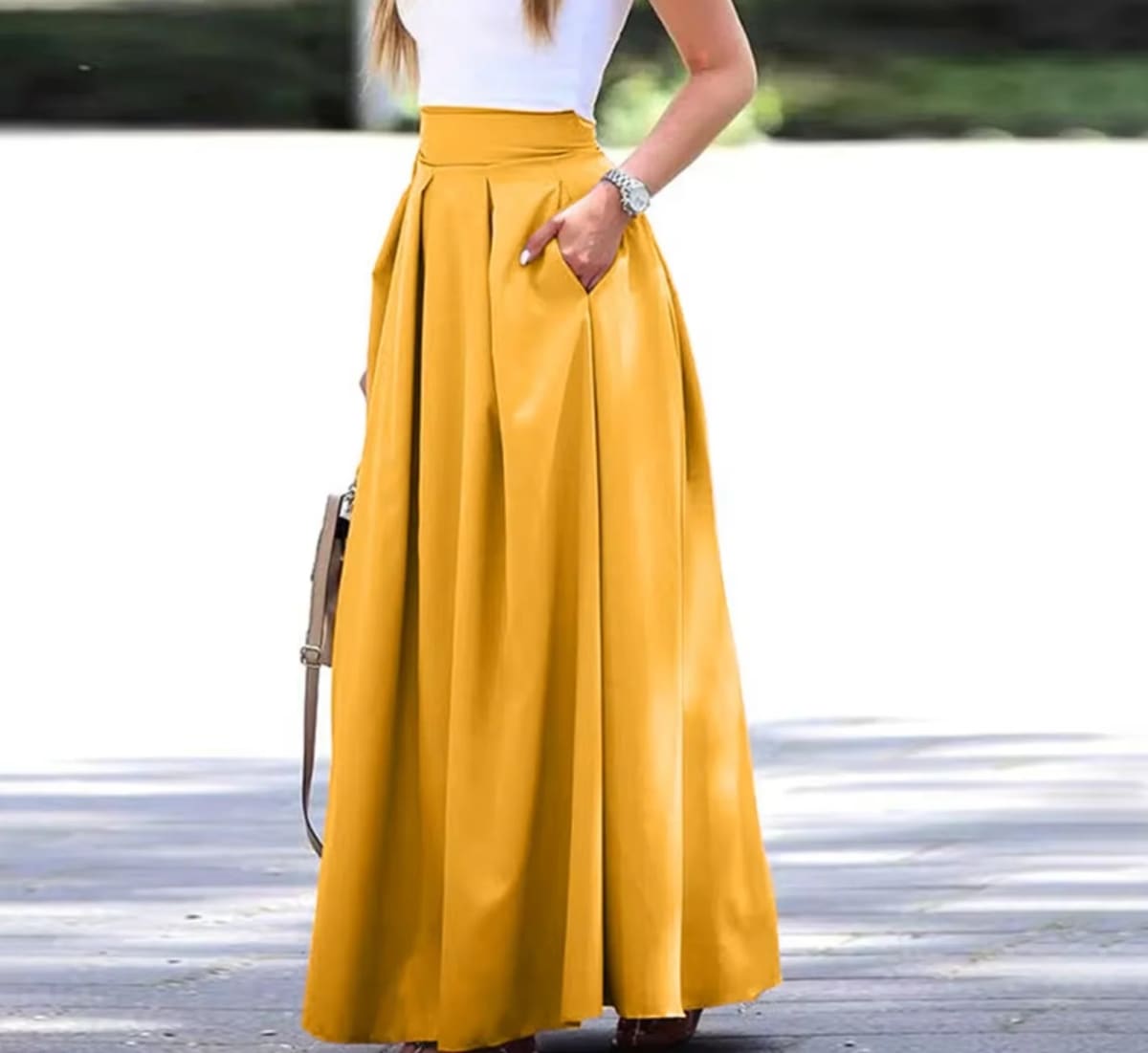 Woman wearing a vibrant red pleated high-waisted maxi skirt.