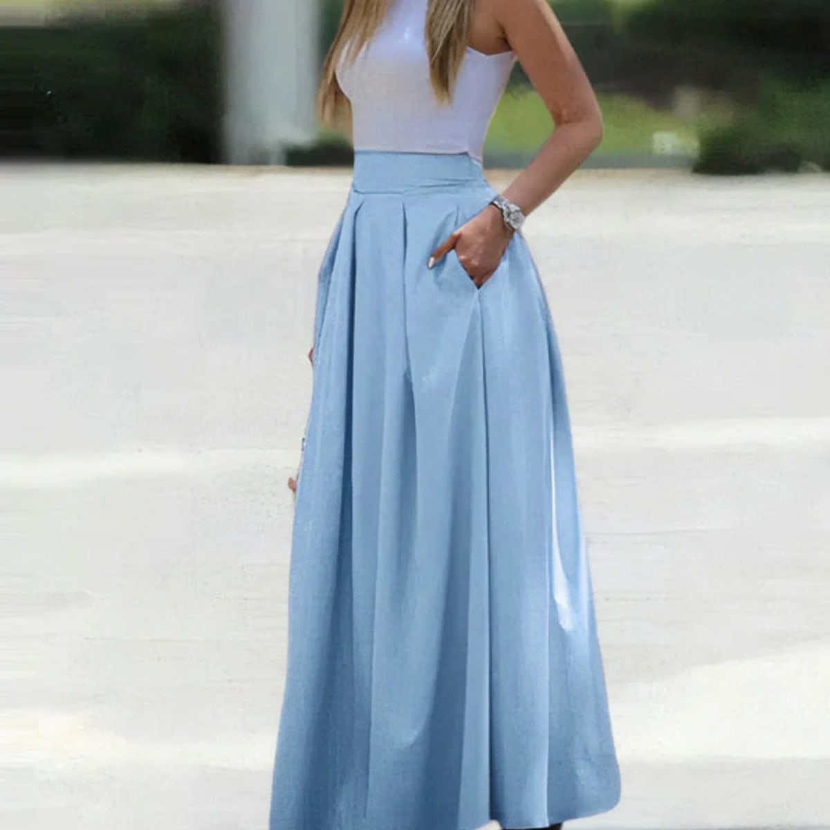Woman wearing a vibrant red pleated high-waisted maxi skirt.