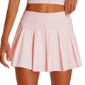 Person wearing light pink pleated mini skirt and matching crop top.