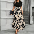 Women's maxi dress with puff sleeves, tie waist, and ruffle hem.