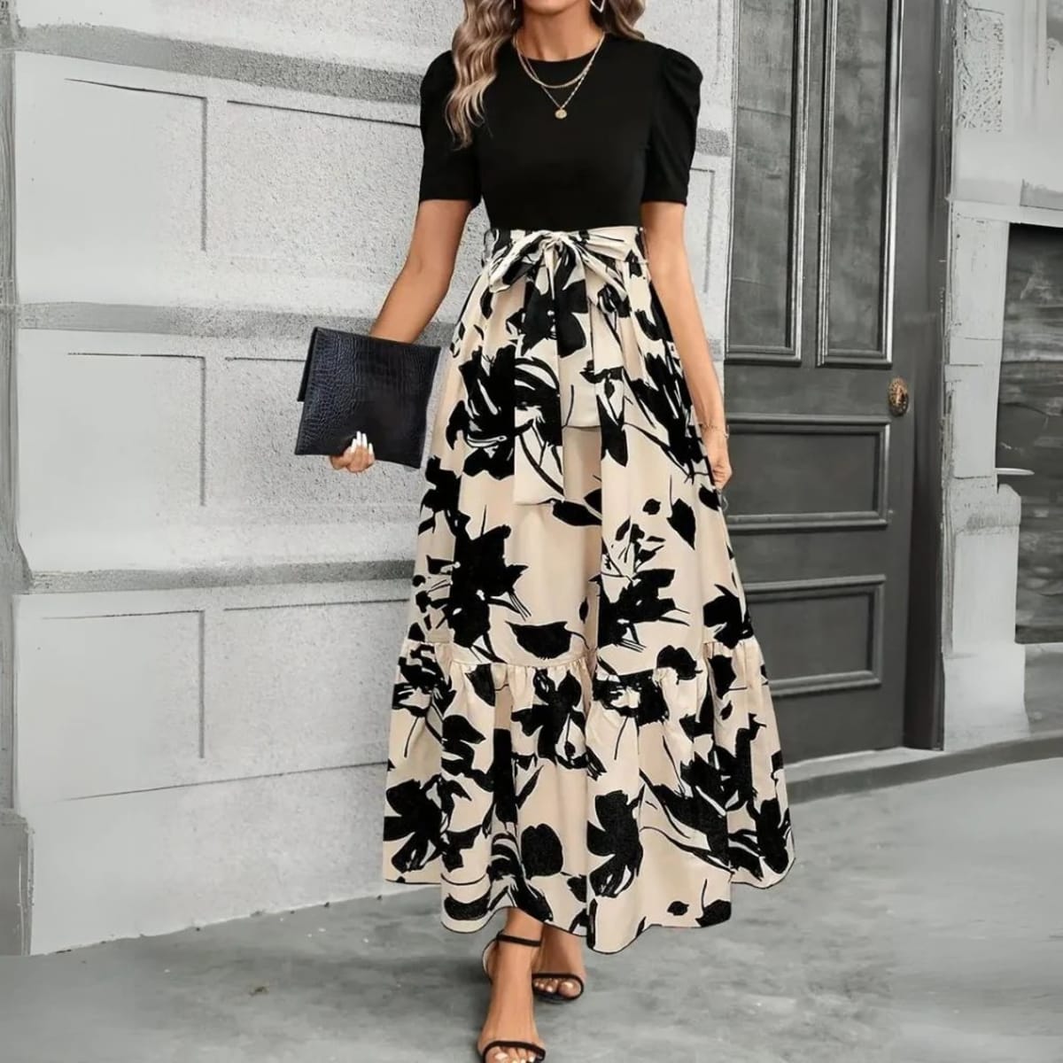Women's maxi dress with puff sleeves, tie waist, and ruffle hem.