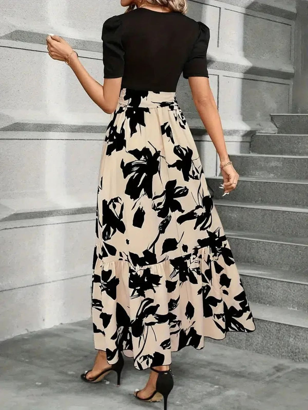 Women's maxi dress with puff sleeves, tie waist, and ruffle hem.