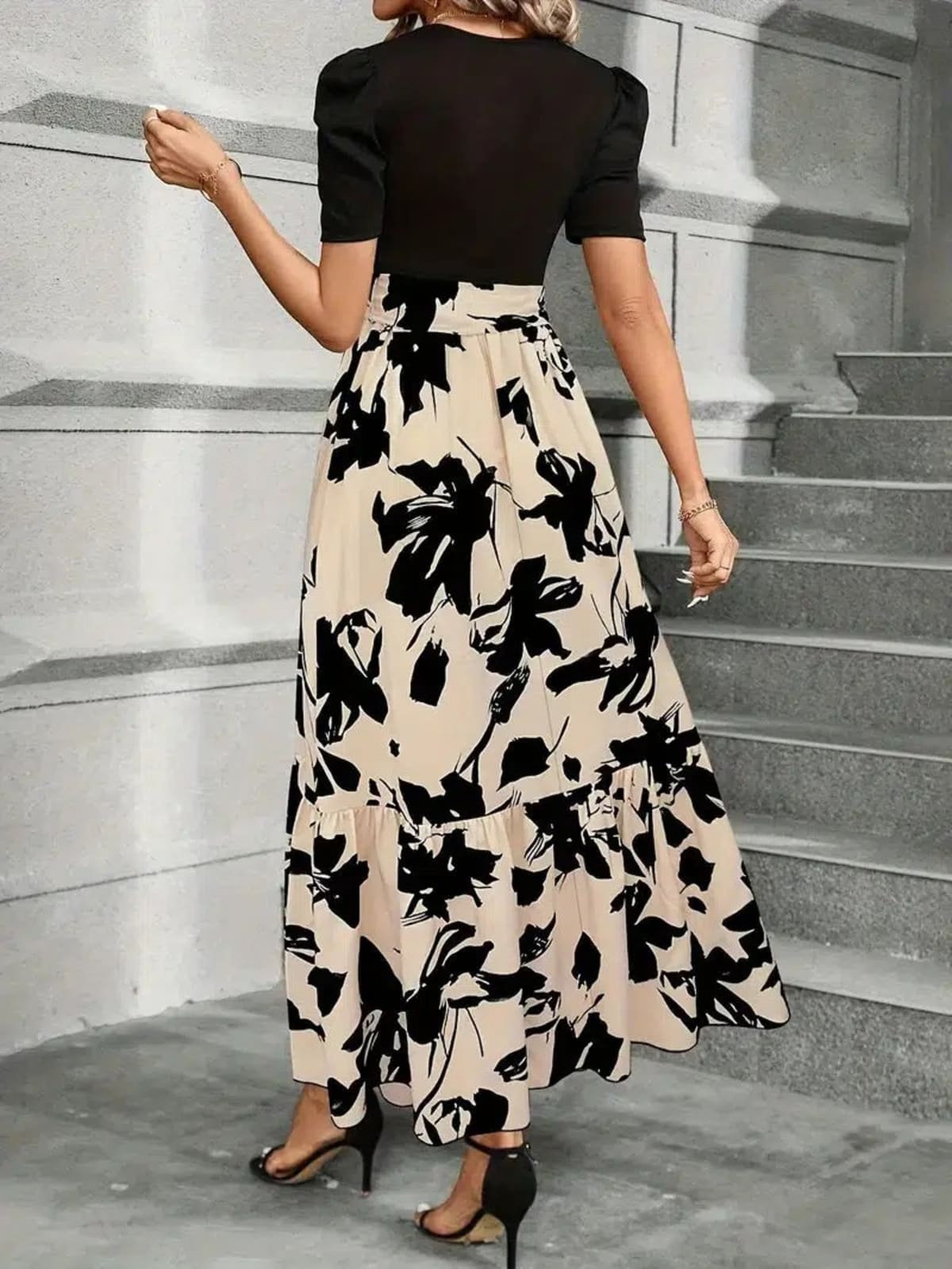 Women's maxi dress with puff sleeves, tie waist, and ruffle hem.