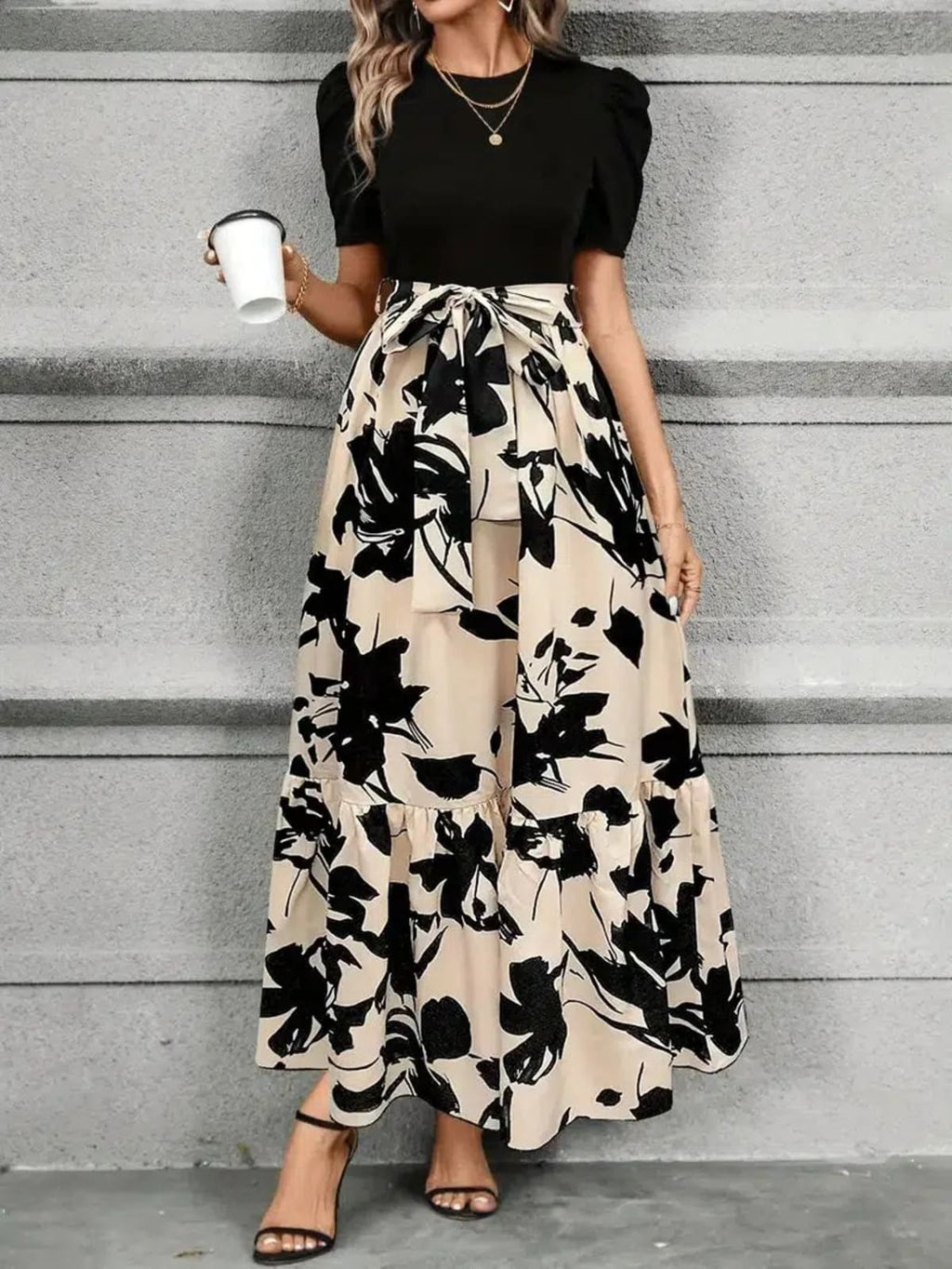 Women's maxi dress with puff sleeves, tie waist, and ruffle hem.