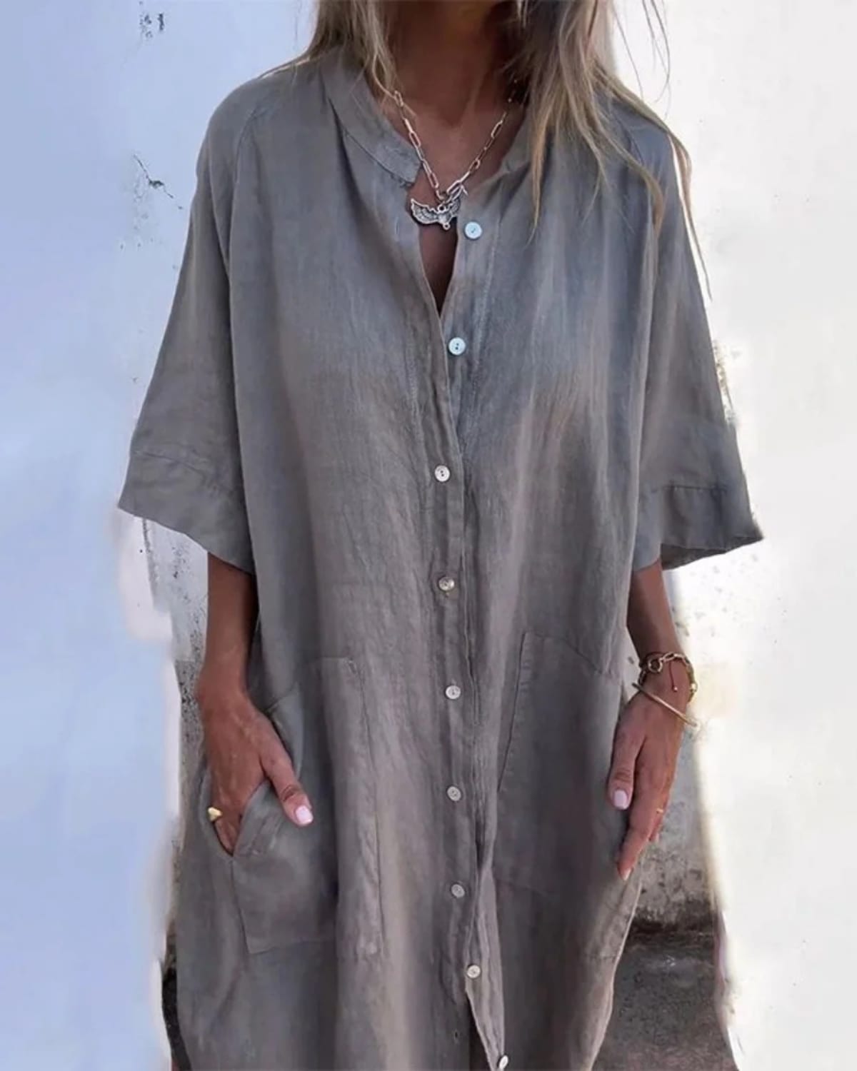 Relaxed fit shirt dress with button-down front and flowing drape.