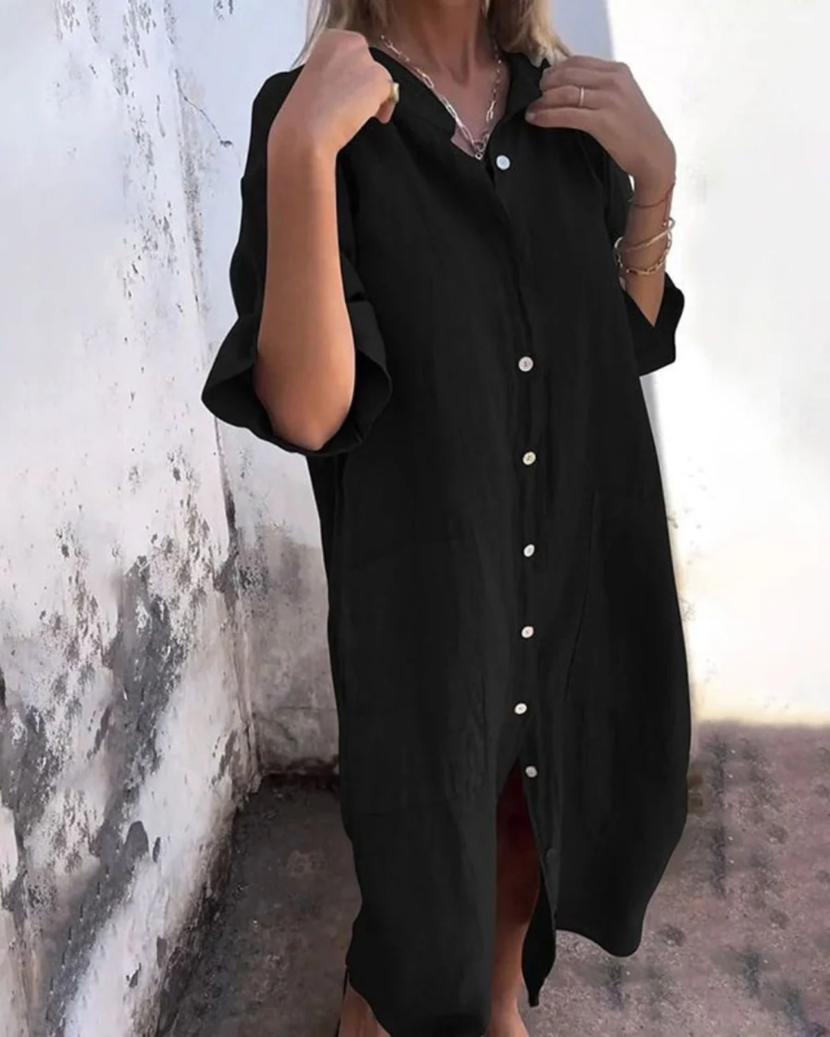 Relaxed fit shirt dress with button-down front and flowing drape.