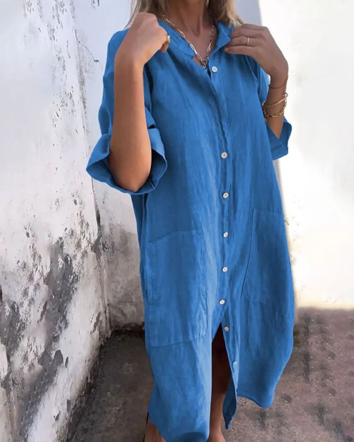 Relaxed fit shirt dress with button-down front and flowing drape.