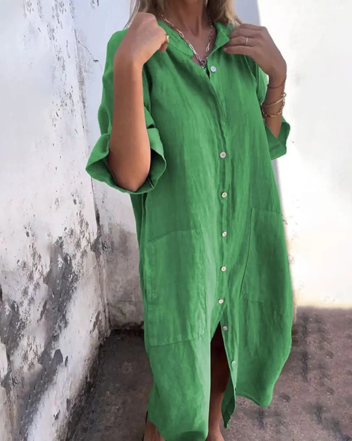 Relaxed fit shirt dress with button-down front and flowing drape.