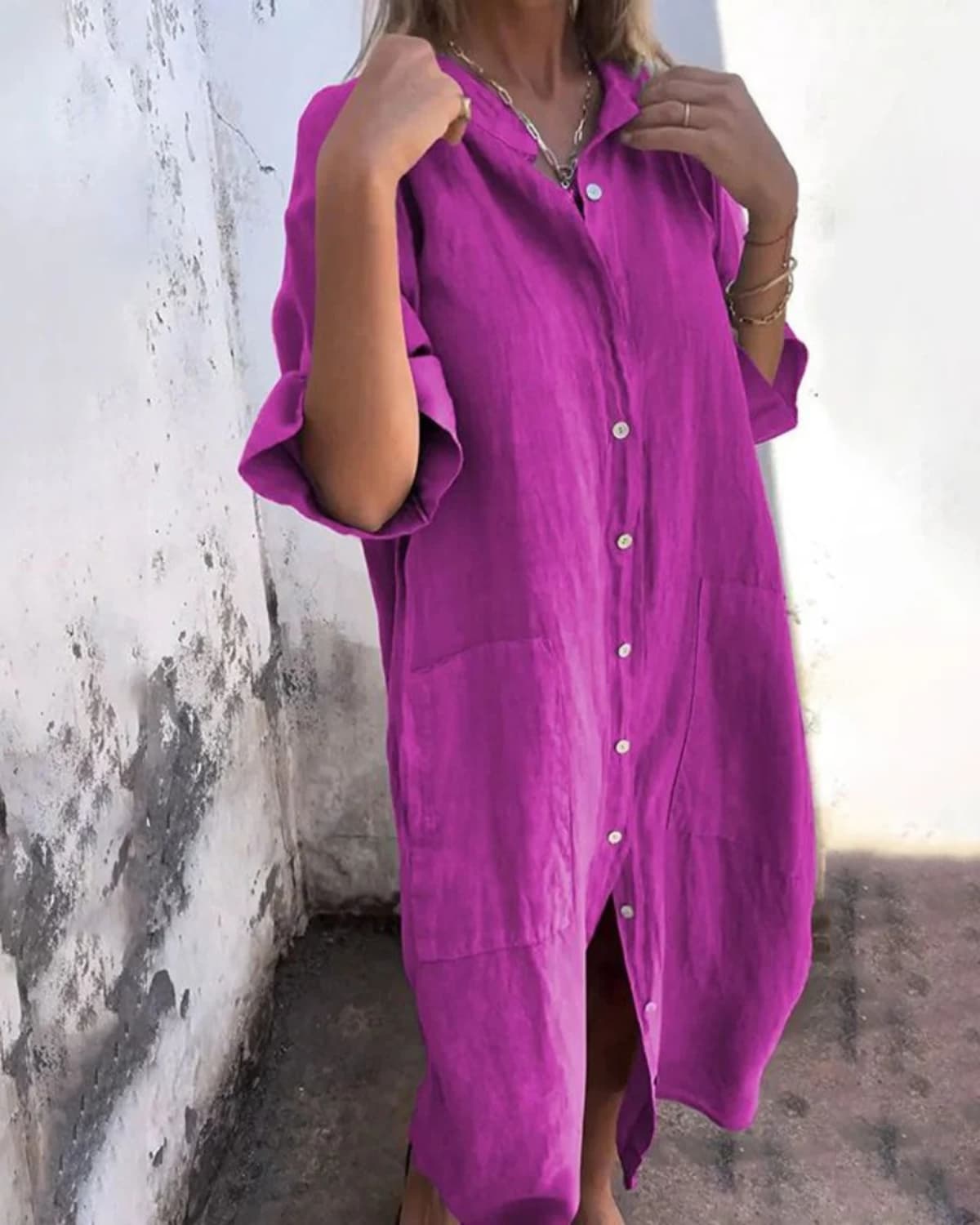 Relaxed fit shirt dress with button-down front and flowing drape.