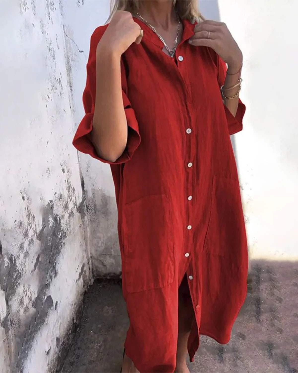 Relaxed fit shirt dress with button-down front and flowing drape.