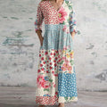Flowing maxi dress with vintage floral pattern in a garden setting.