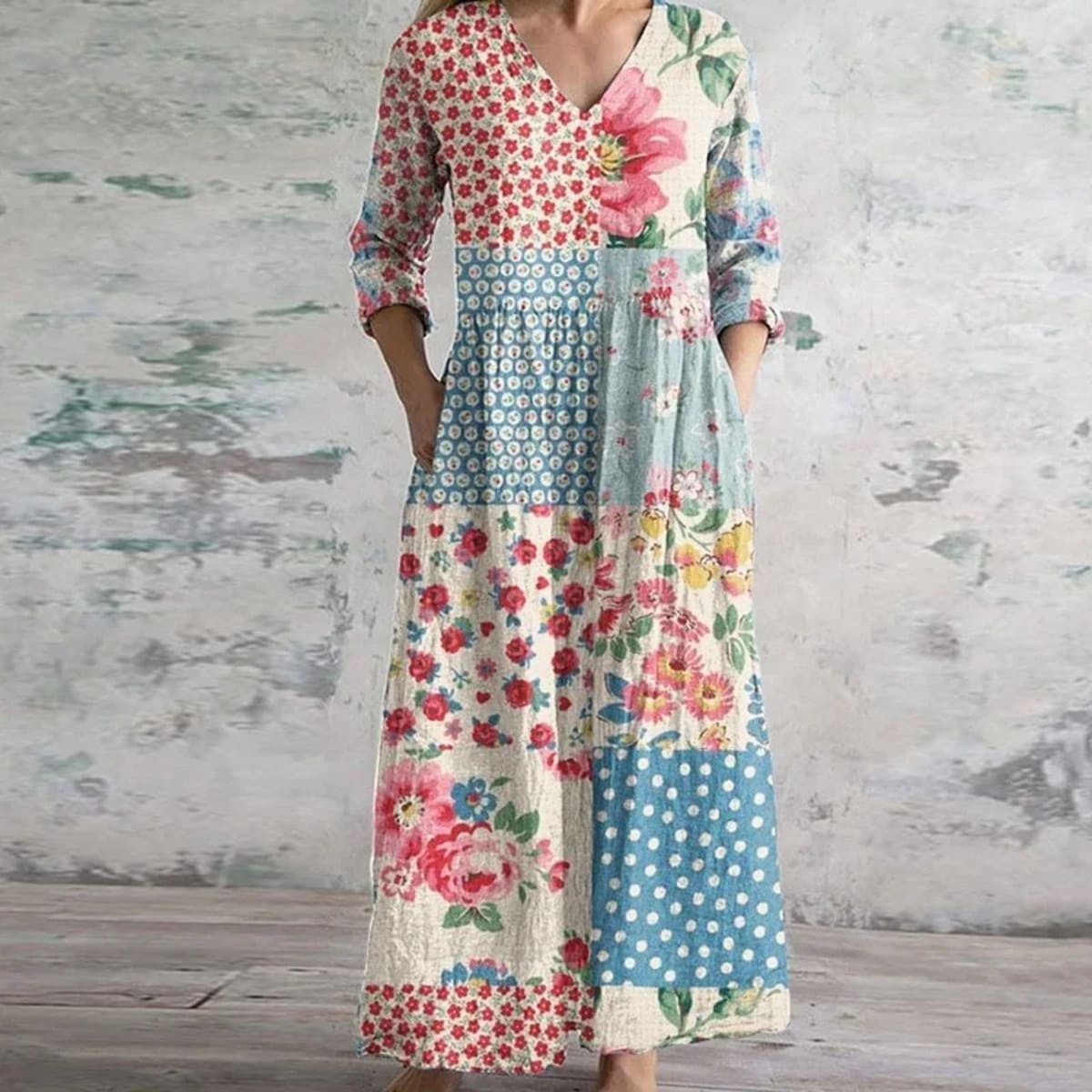 Flowing maxi dress with vintage floral pattern in a garden setting.