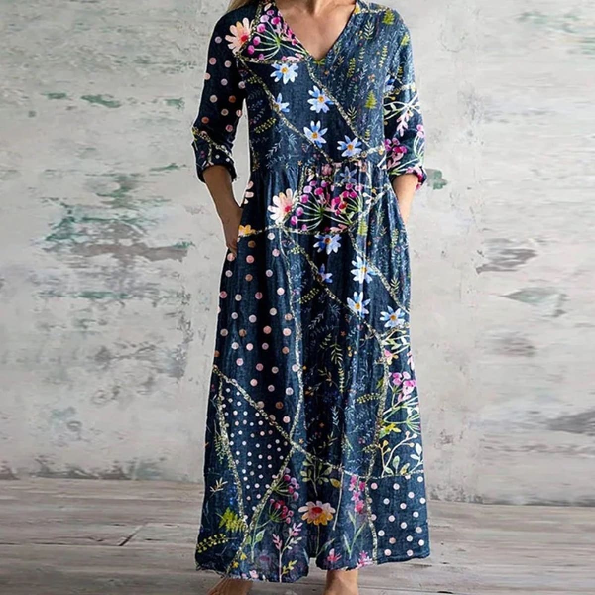 Flowing maxi dress with vintage floral pattern in a garden setting.