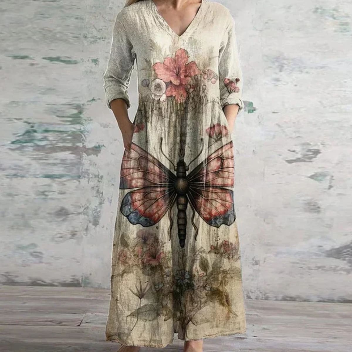 Flowing maxi dress with vintage floral pattern in a garden setting.
