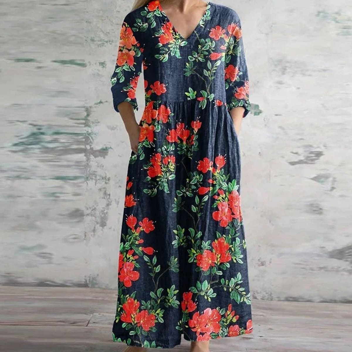 Flowing maxi dress with vintage floral pattern in a garden setting.