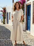 Women's round neck maxi dress with pockets and tie detail.
