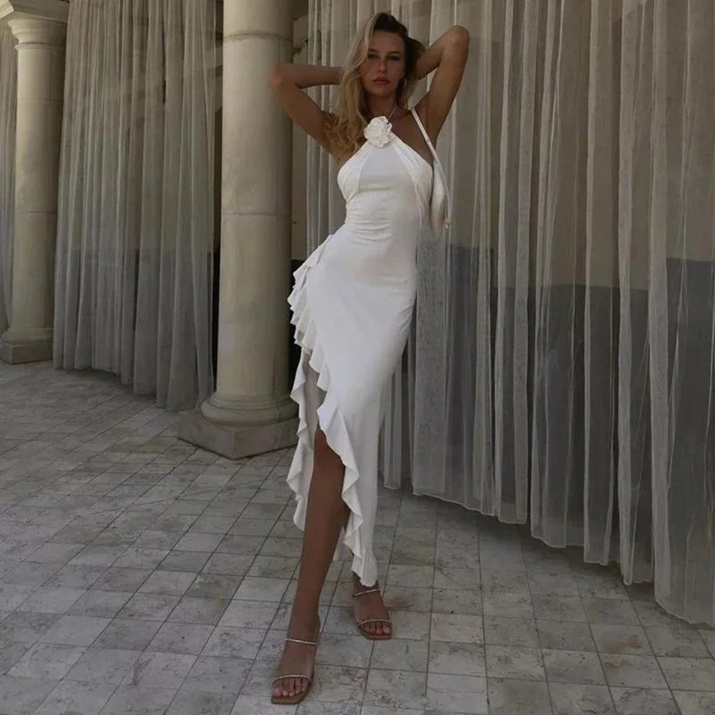Woman on staircase wearing asymmetrical ruffled halter maxi dress