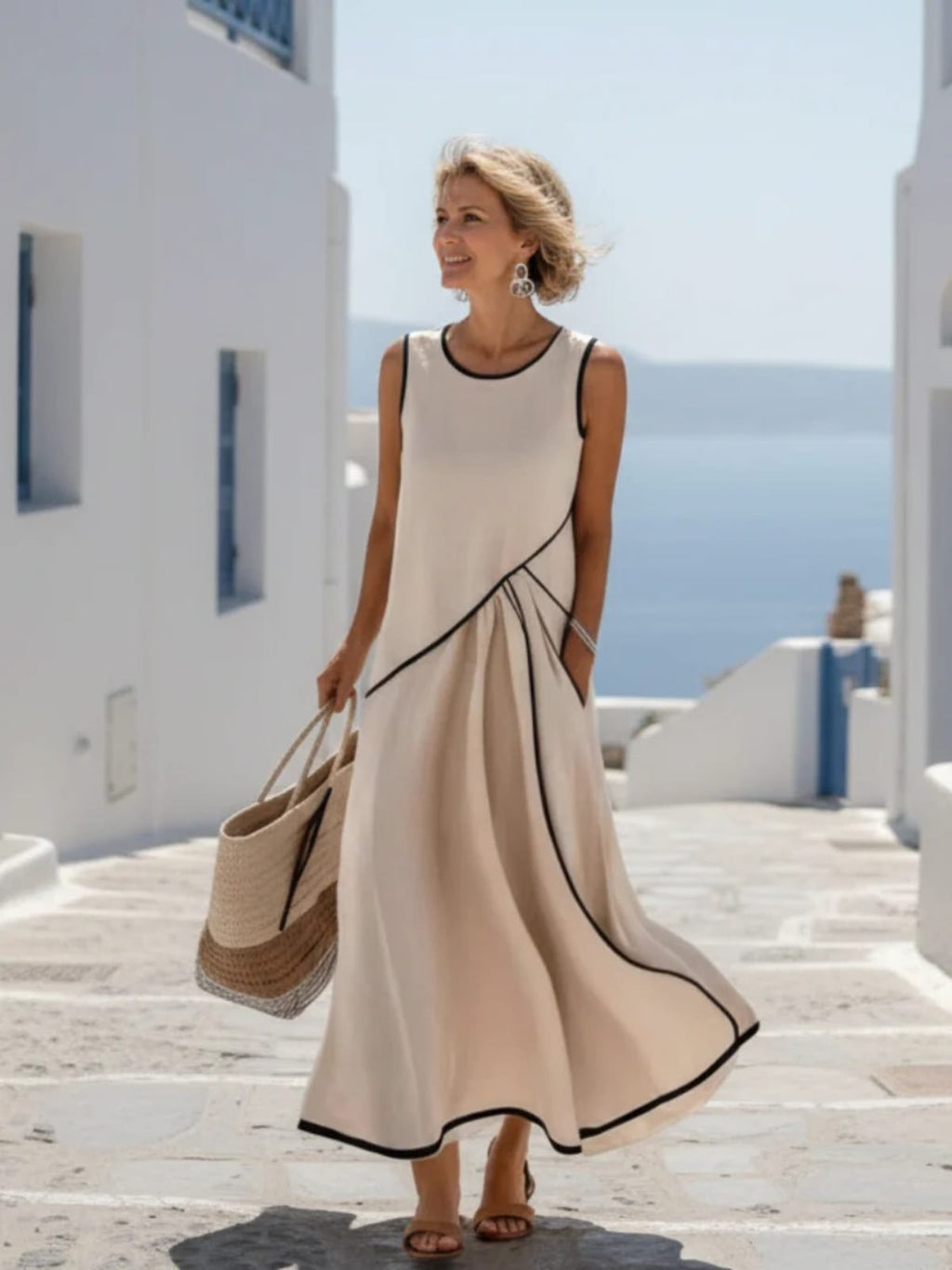 Sleeveless maxi dress with round neck and draped sides.