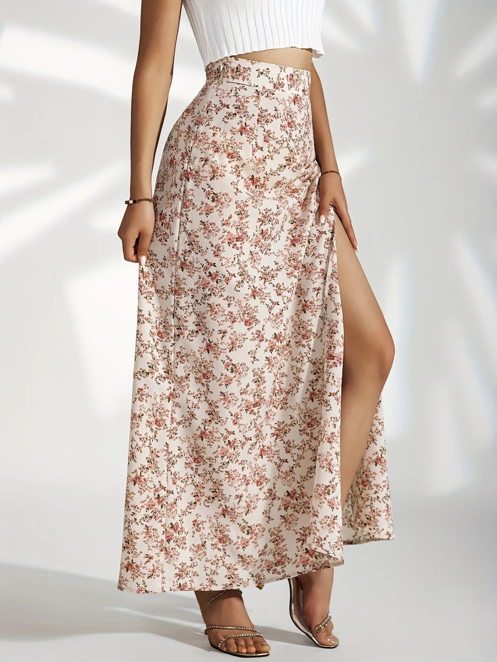 Woman wearing high-waisted floral maxi skirt with slit.