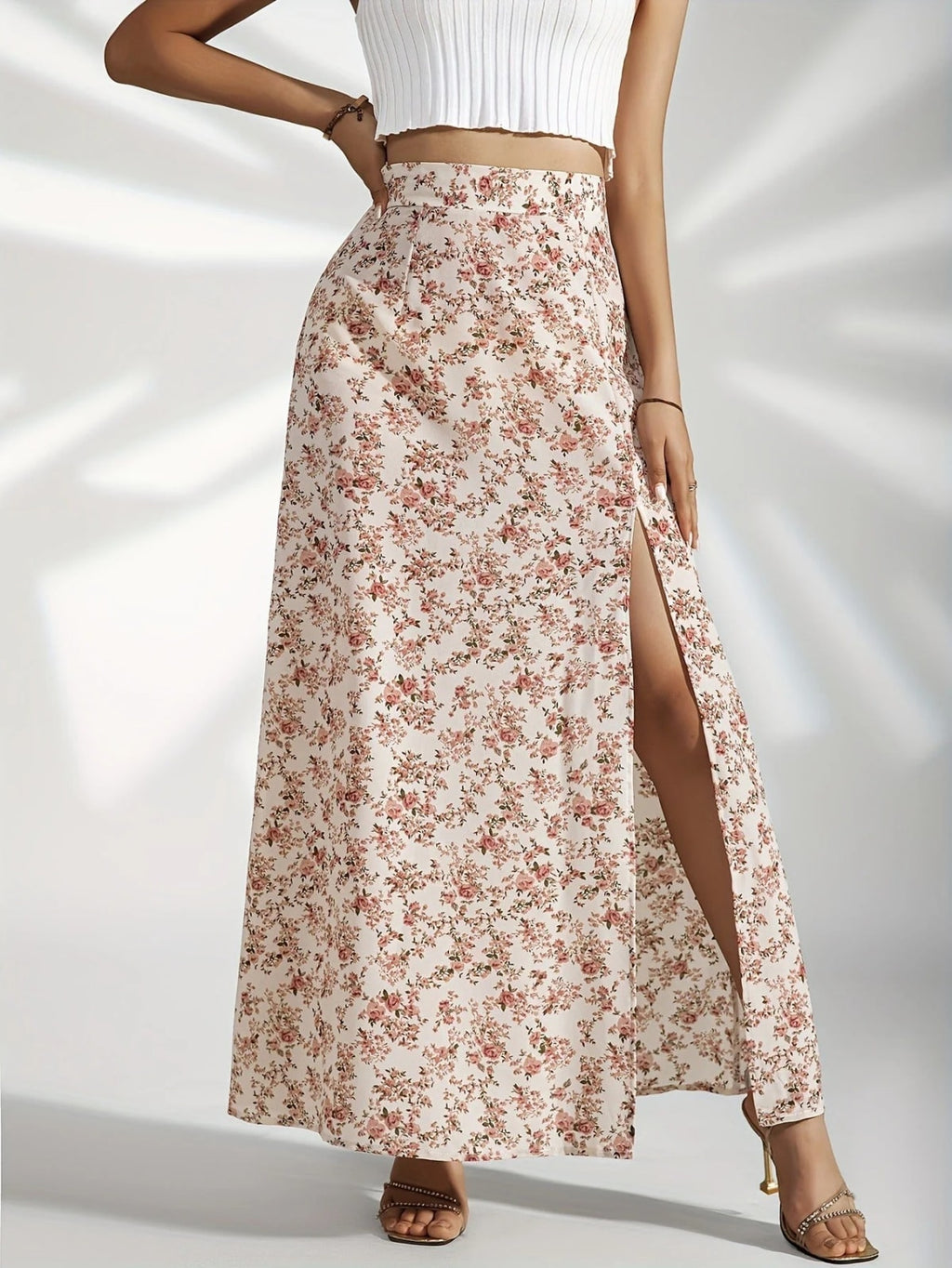 Woman wearing high-waisted floral maxi skirt with slit.