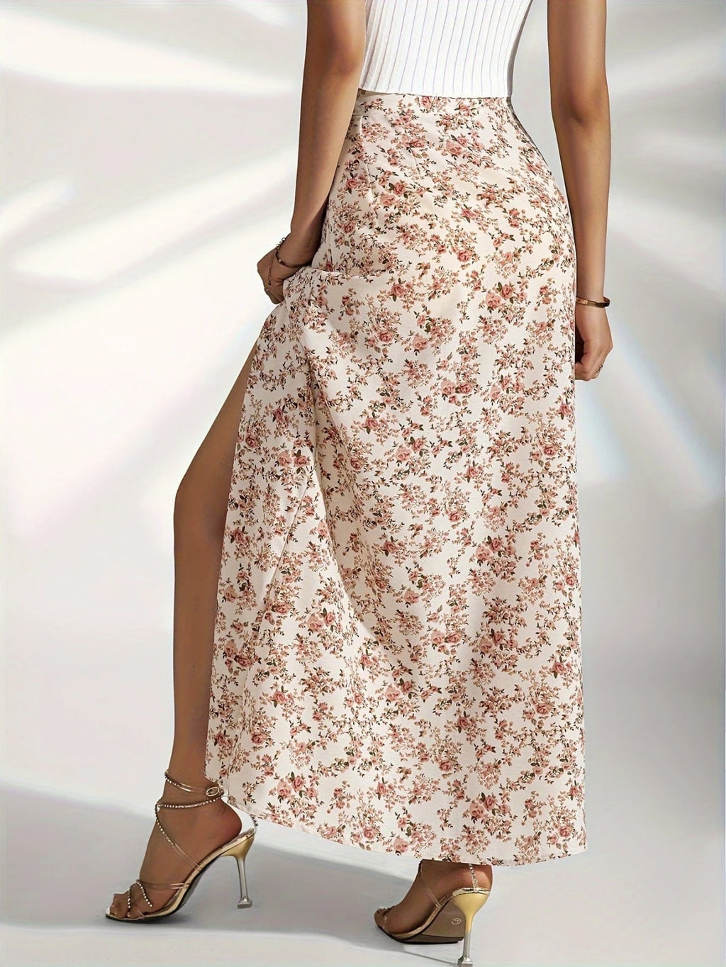 Woman wearing high-waisted floral maxi skirt with slit.