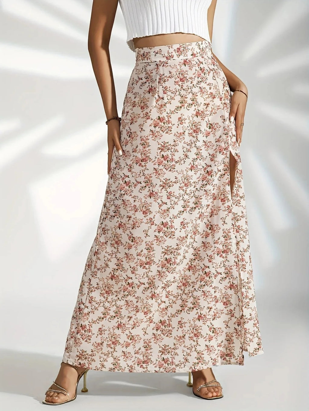 Woman wearing high-waisted floral maxi skirt with slit.