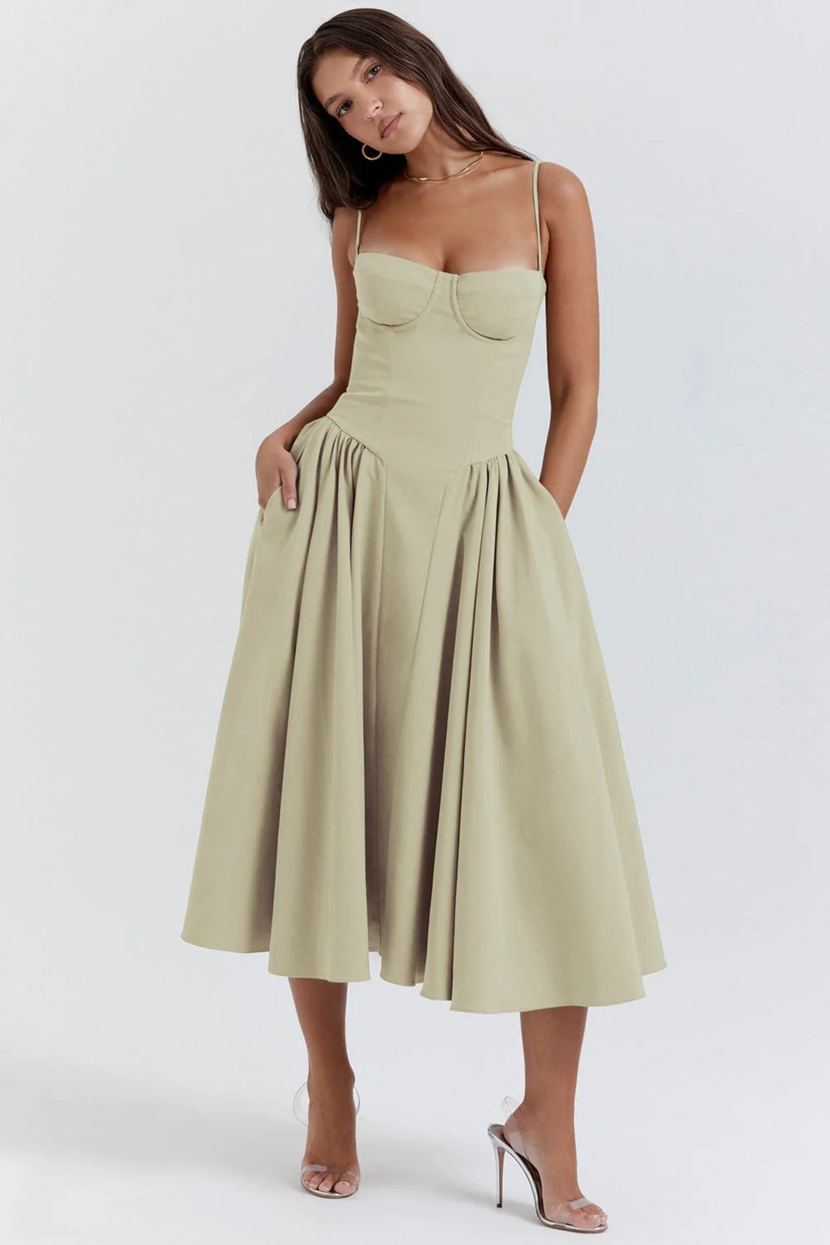 Woman wearing a bustier midi dress with spaghetti straps and A-line skirt.
