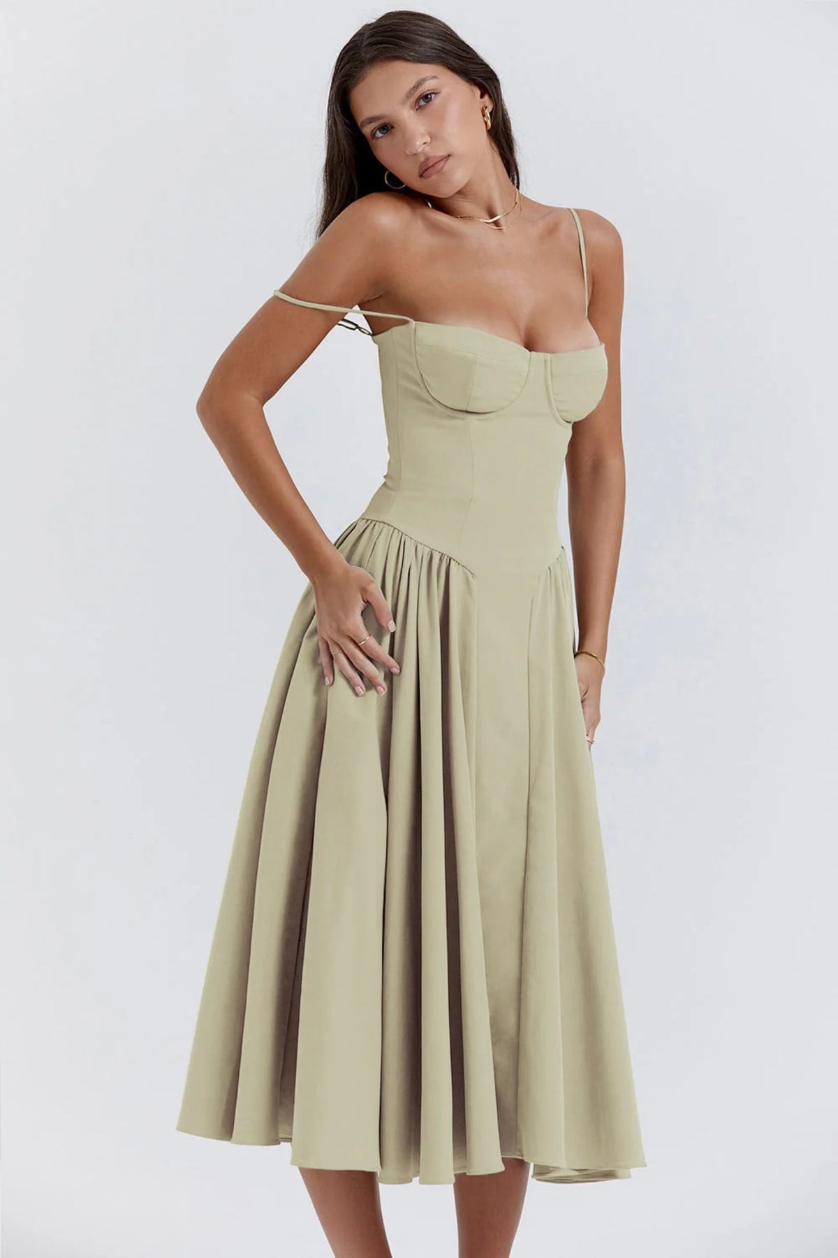 Woman wearing a bustier midi dress with spaghetti straps and A-line skirt.
