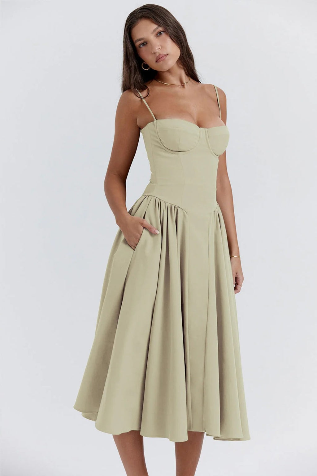 Woman wearing a bustier midi dress with spaghetti straps and A-line skirt.