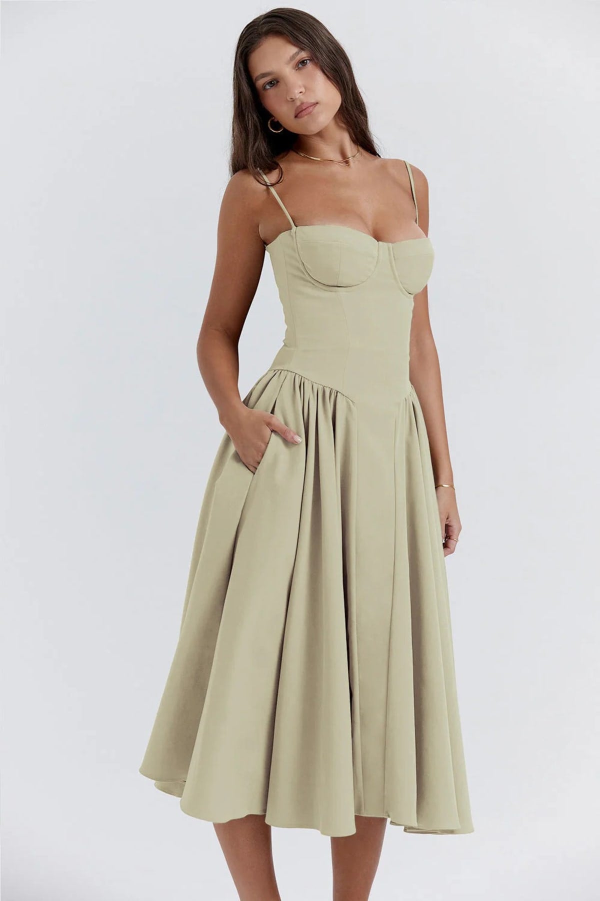 Woman wearing a bustier midi dress with spaghetti straps and A-line skirt.