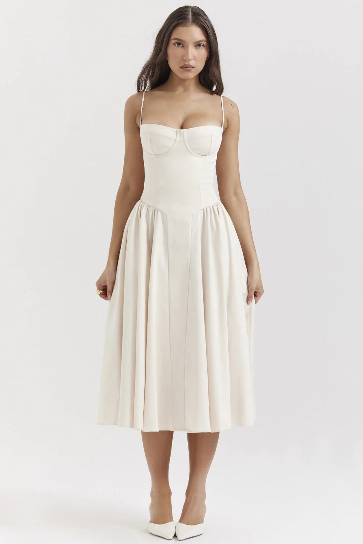 Woman wearing a bustier midi dress with spaghetti straps and A-line skirt.